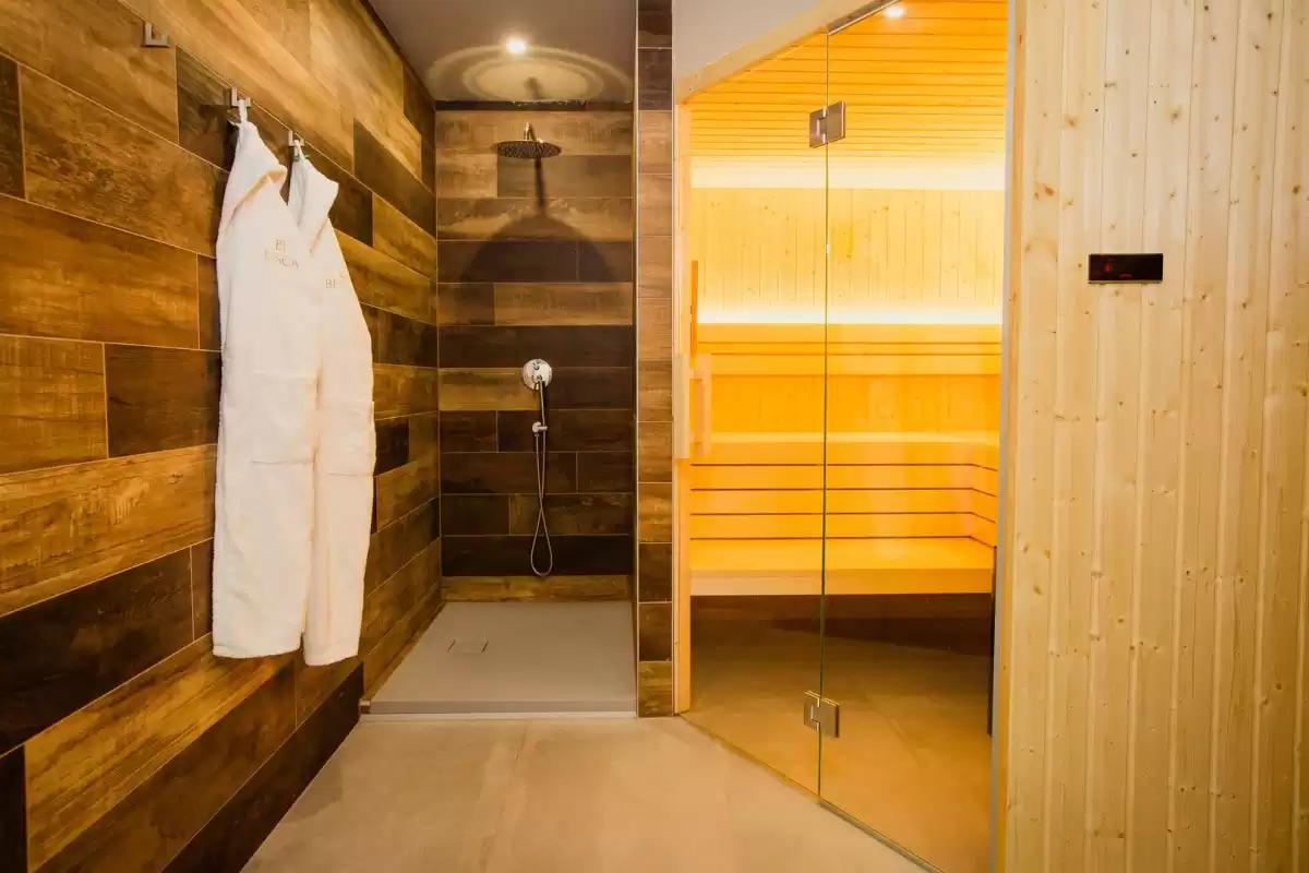Wellness area in Villa Besca featuring a modern sauna and stylish shower, perfect for relaxation and rejuvenation.