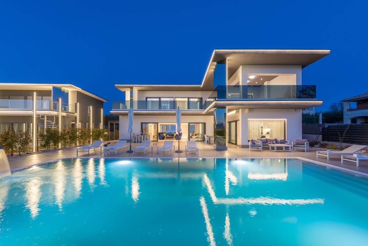 Modern two-storey villa with its pool lit at dusk, Villa Castanea Estate near Poreč, Istria