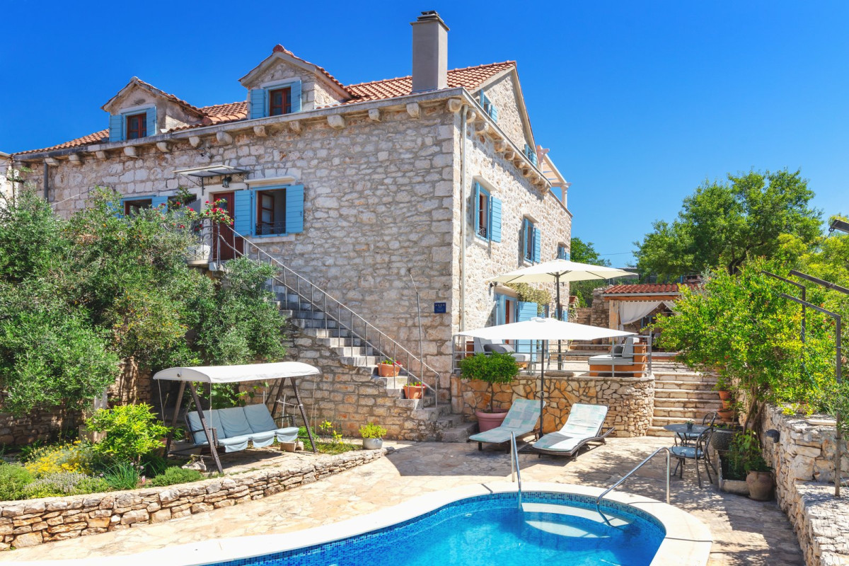Traditional stone house with blue shutters, a garden terrace and a pool, Villa Vicina on the island of Brač